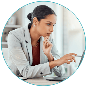 A woman looks focused at her computer.